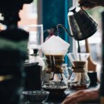 coffee shop with kettle pouring in coffee pitcher