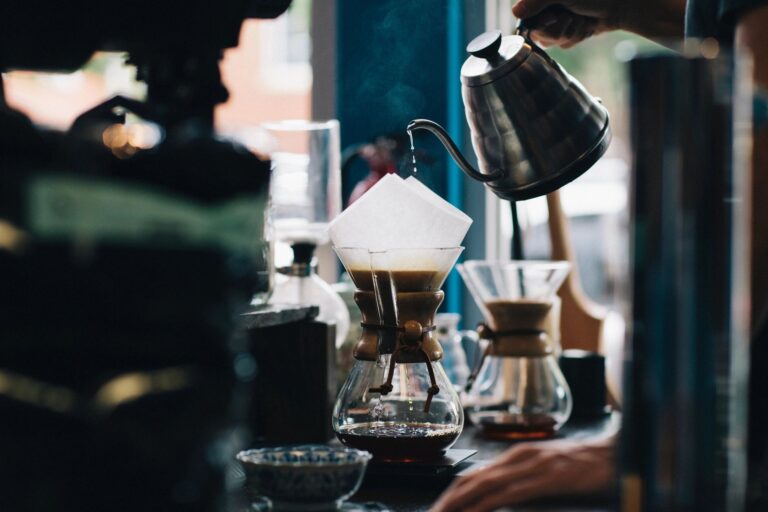 coffee shop with kettle pouring in coffee pitcher